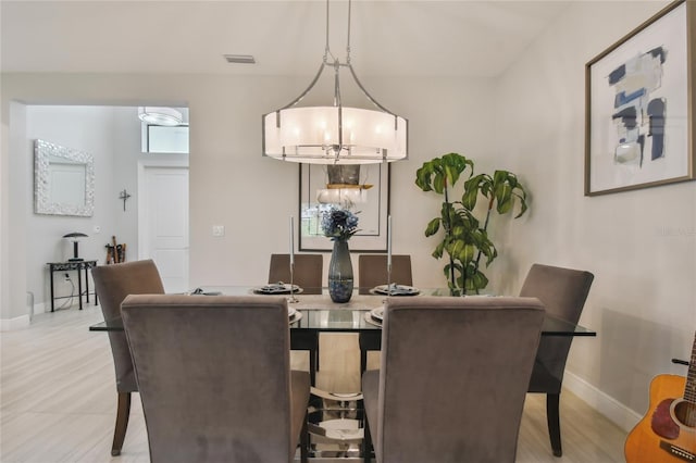 dining space with an inviting chandelier