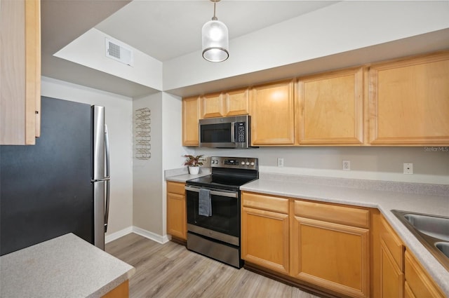 kitchen featuring sink, light hardwood / wood-style flooring, appliances with stainless steel finishes, decorative light fixtures, and light brown cabinets