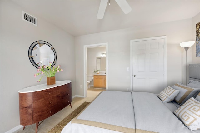 carpeted bedroom featuring ensuite bathroom and ceiling fan