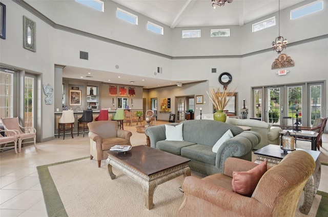 living room featuring light tile patterned floors, french doors, and a chandelier