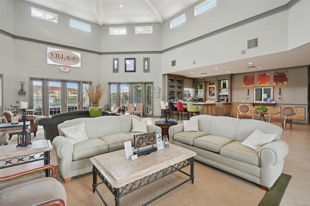 tiled living room featuring french doors and a healthy amount of sunlight