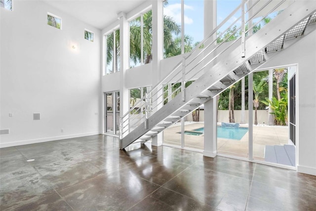 unfurnished living room with a high ceiling