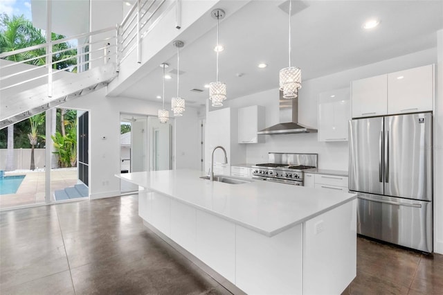 kitchen with an island with sink, sink, stainless steel appliances, and white cabinets