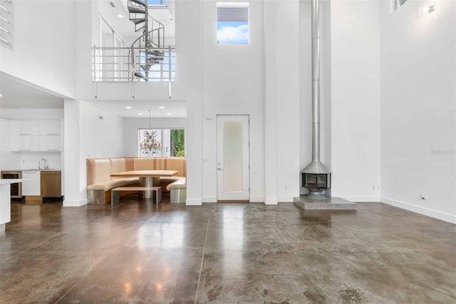 unfurnished living room with sink and a high ceiling