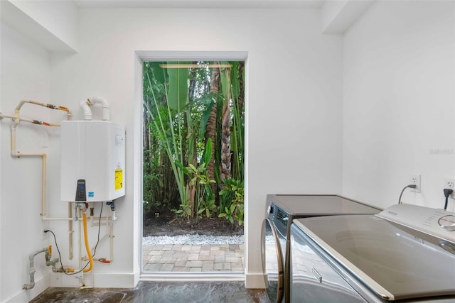 laundry room with washer and clothes dryer and tankless water heater