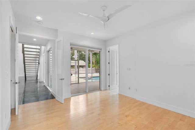 empty room with light hardwood / wood-style floors and ceiling fan