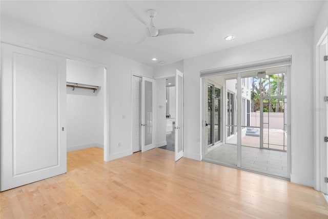 unfurnished bedroom with light hardwood / wood-style floors, access to exterior, a closet, ceiling fan, and french doors