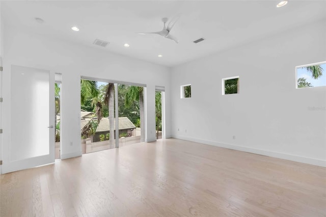 unfurnished room with light wood-type flooring and ceiling fan