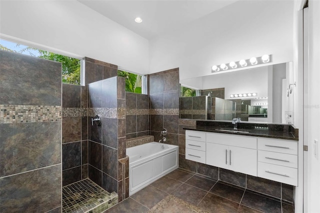 bathroom featuring independent shower and bath and vanity