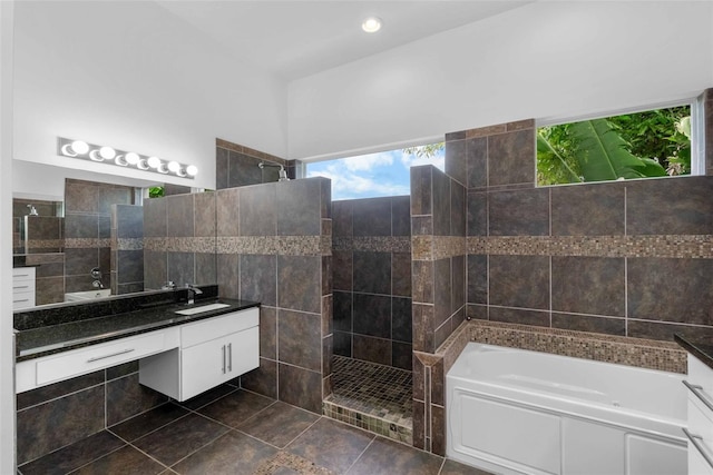 bathroom featuring tile walls, vanity, and separate shower and tub