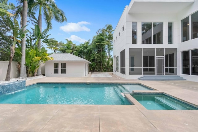 view of swimming pool featuring an in ground hot tub and a patio area