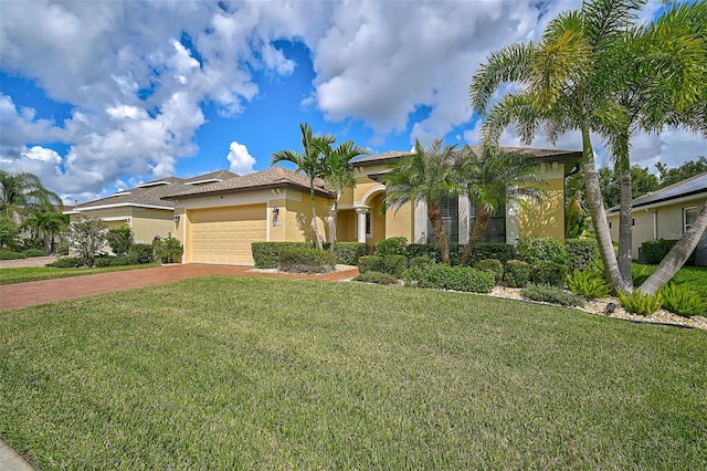 mediterranean / spanish-style home with a garage and a front yard