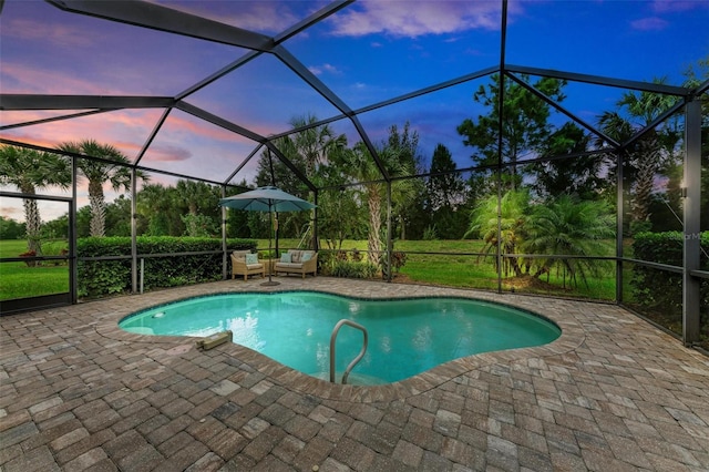 pool at dusk with a patio area and glass enclosure