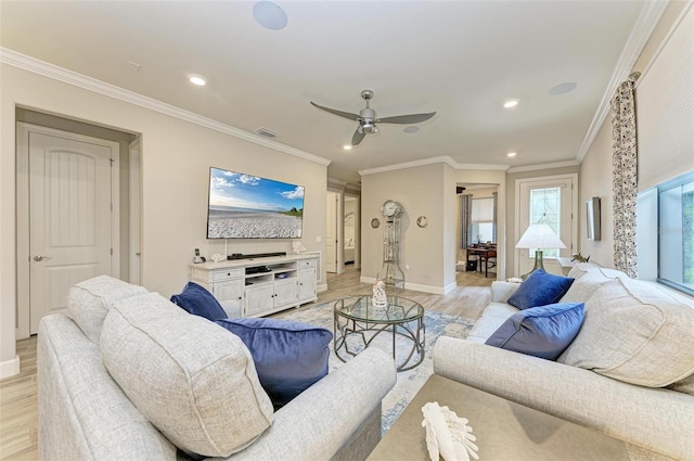 living room with ceiling fan, ornamental molding, and light wood-type flooring