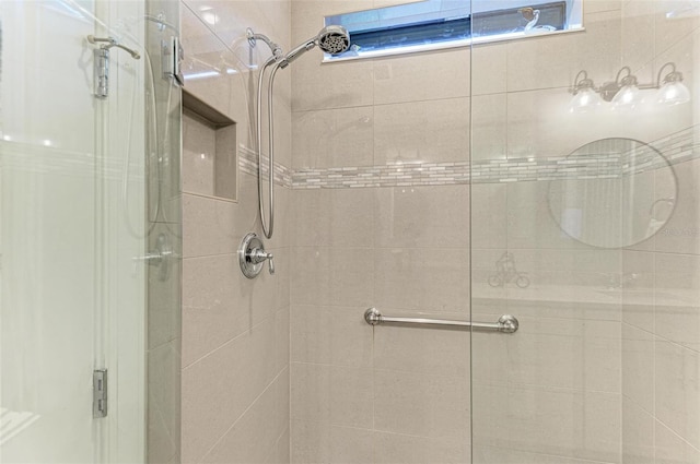 bathroom featuring a shower with shower door