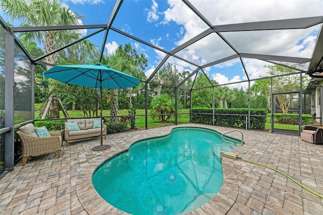 view of swimming pool featuring a lanai, outdoor lounge area, and a patio area