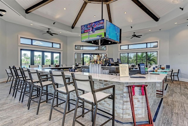 dining area with beamed ceiling, wood ceiling, high vaulted ceiling, and light hardwood / wood-style floors