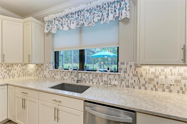 kitchen with light stone counters, sink, decorative backsplash, and dishwasher