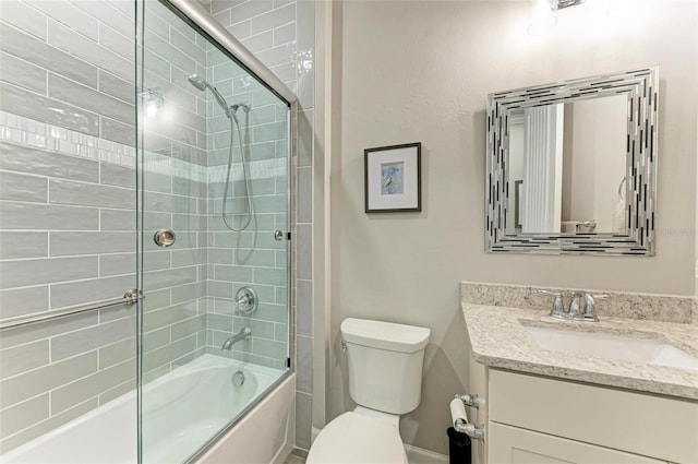 full bathroom with vanity, enclosed tub / shower combo, and toilet