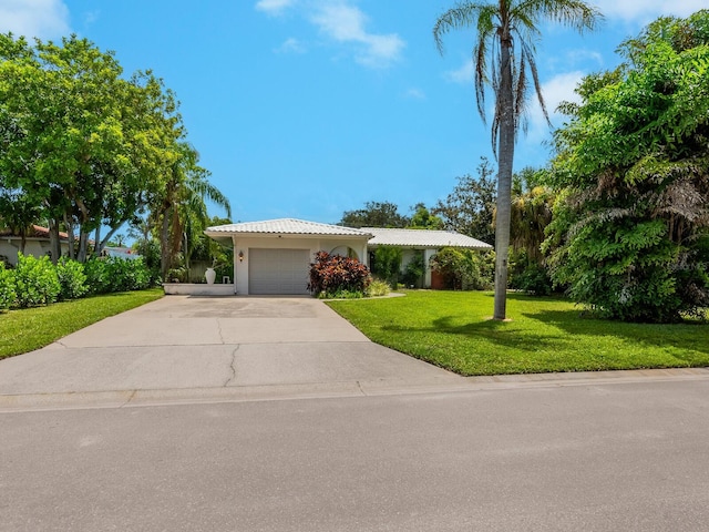 ranch-style home featuring a front lawn and a garage