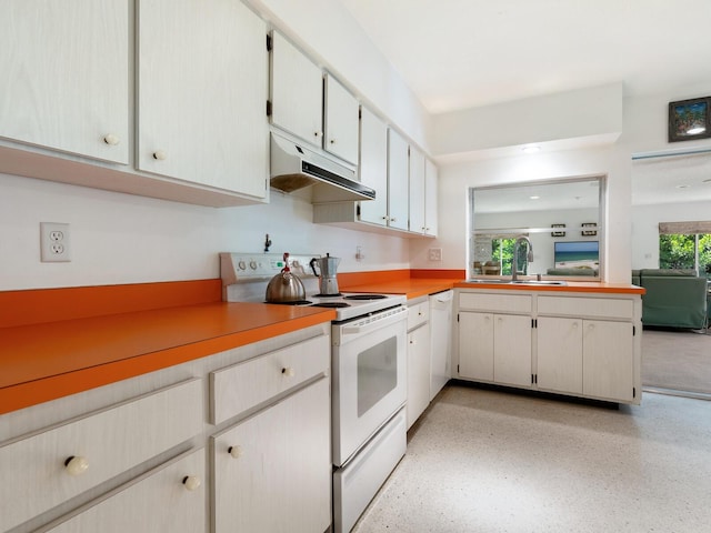 kitchen featuring white appliances, sink, and white cabinets