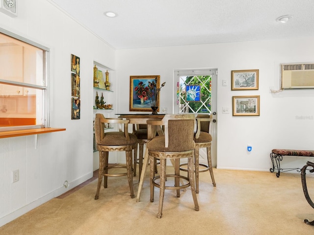 carpeted dining room with a wall unit AC