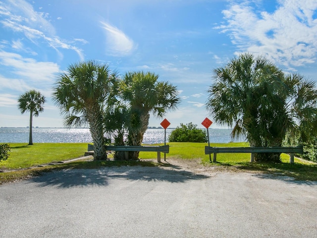 view of home's community featuring a water view and a yard