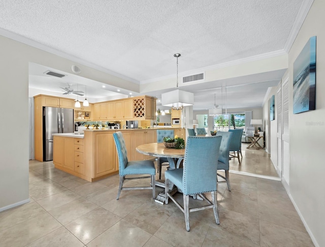 dining room featuring light tile patterned flooring, ceiling fan, crown molding, and a textured ceiling