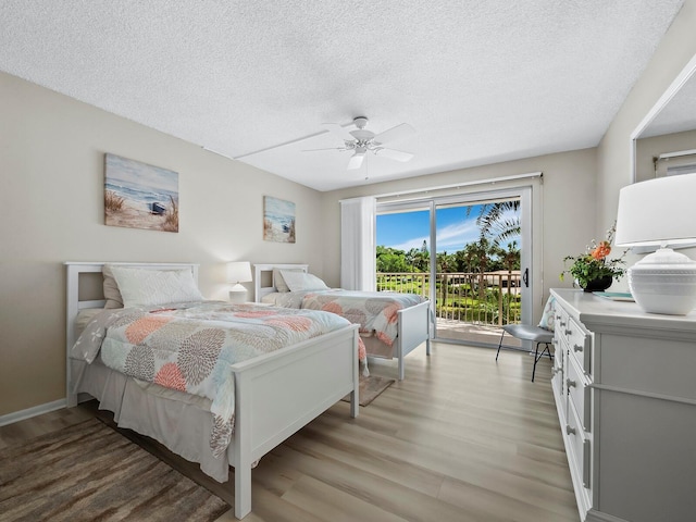 bedroom featuring ceiling fan, a textured ceiling, access to outside, and wood-type flooring