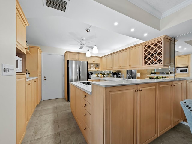 kitchen featuring light brown cabinetry, kitchen peninsula, white microwave, ornamental molding, and ceiling fan