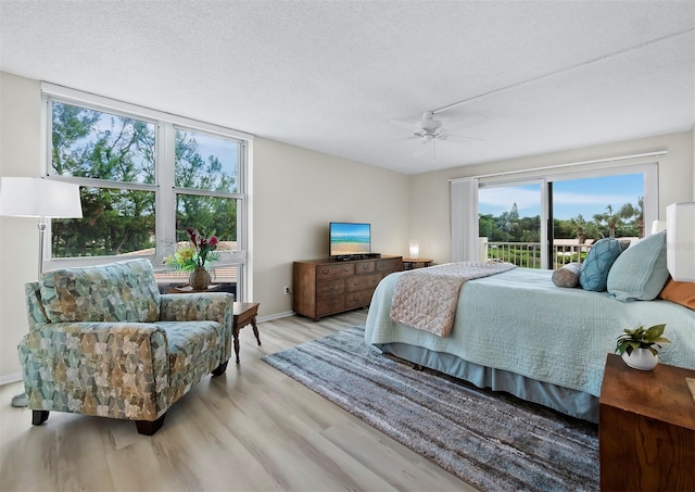 bedroom featuring a textured ceiling, hardwood / wood-style flooring, and ceiling fan