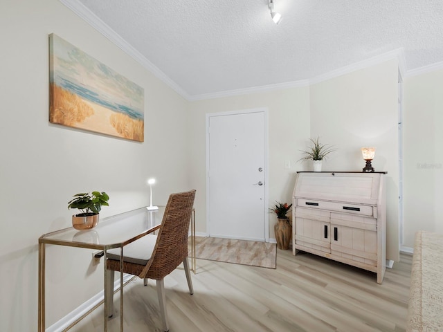 office with light wood-type flooring, ornamental molding, and a textured ceiling