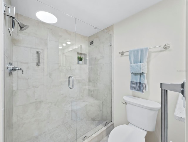 bathroom featuring toilet and walk in shower