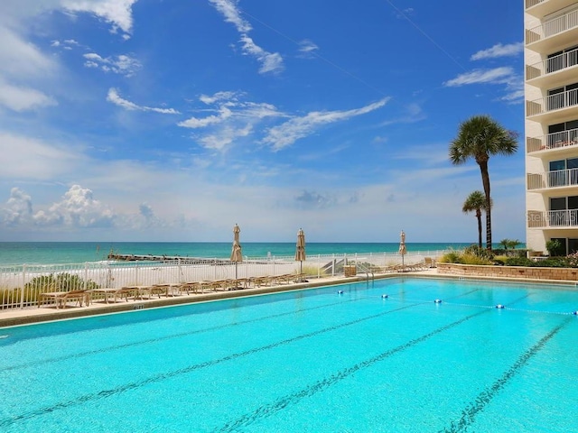 view of swimming pool with a water view