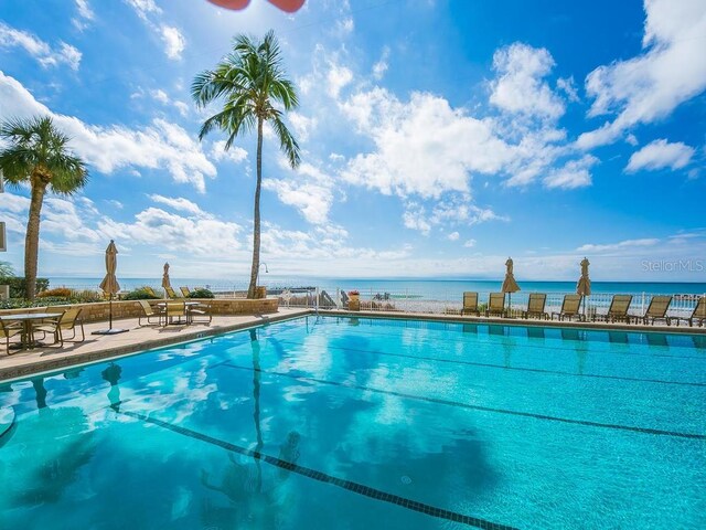 view of swimming pool featuring a water view