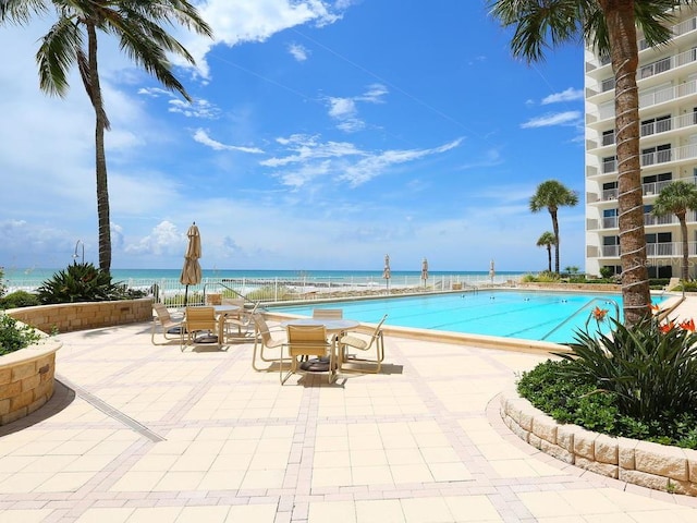 view of pool with a water view