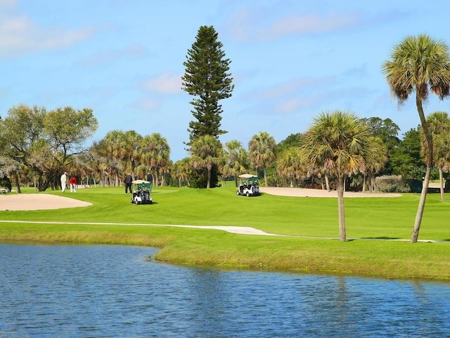 surrounding community featuring a water view and a yard