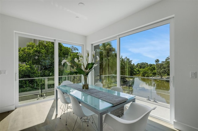 sunroom / solarium with a water view