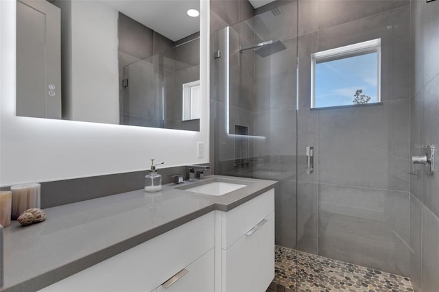 bathroom featuring vanity and an enclosed shower