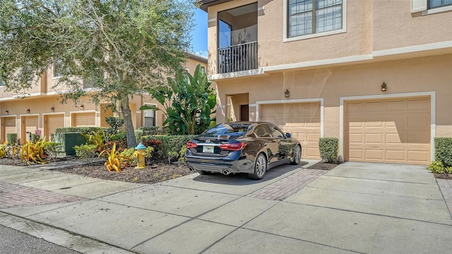 view of front of house featuring a garage and a balcony