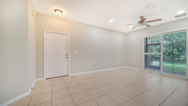 tiled empty room with ceiling fan