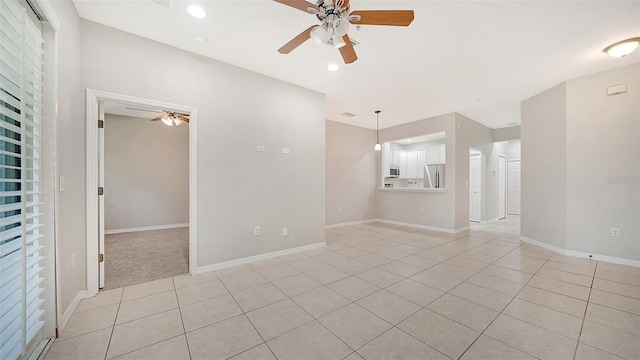 tiled spare room with ceiling fan