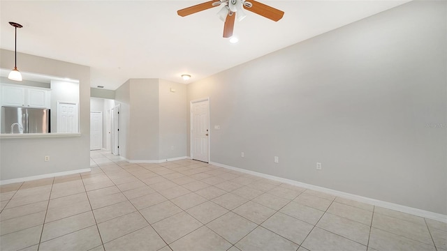 tiled spare room with ceiling fan