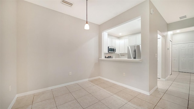 unfurnished dining area with light tile patterned floors