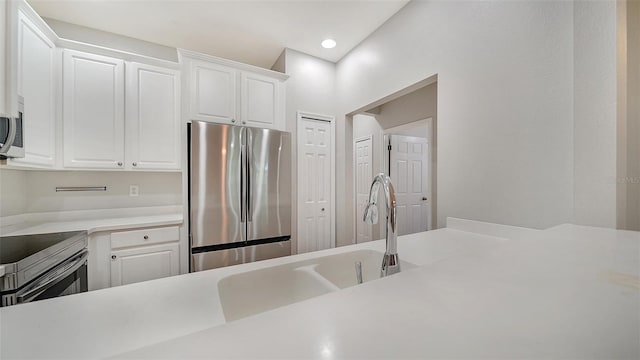 kitchen with stainless steel appliances and white cabinetry