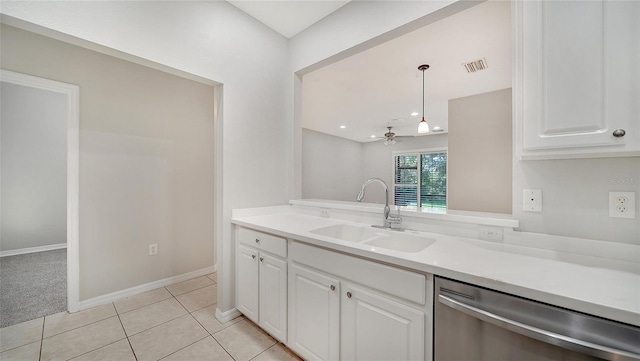 kitchen with dishwasher, sink, hanging light fixtures, and white cabinets