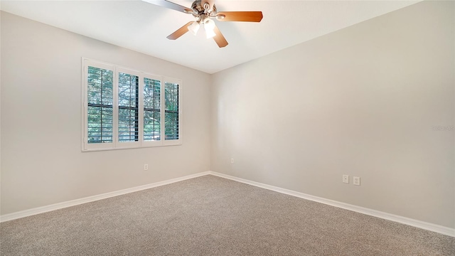 carpeted spare room with ceiling fan