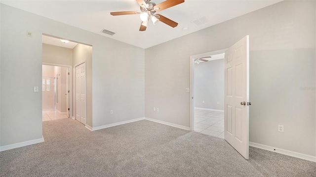 carpeted spare room with ceiling fan