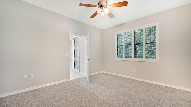 spare room featuring ceiling fan and light carpet