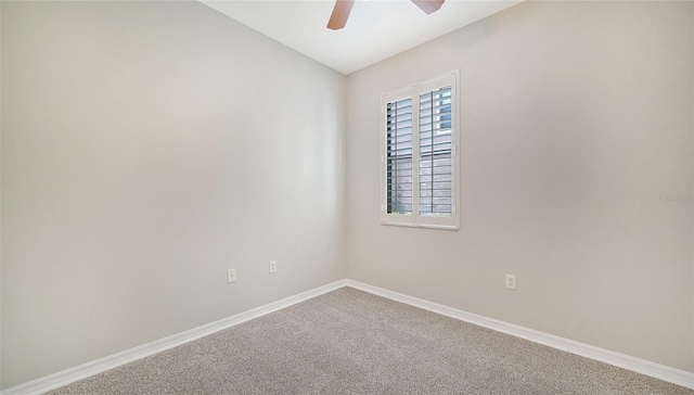 unfurnished room featuring ceiling fan and carpet